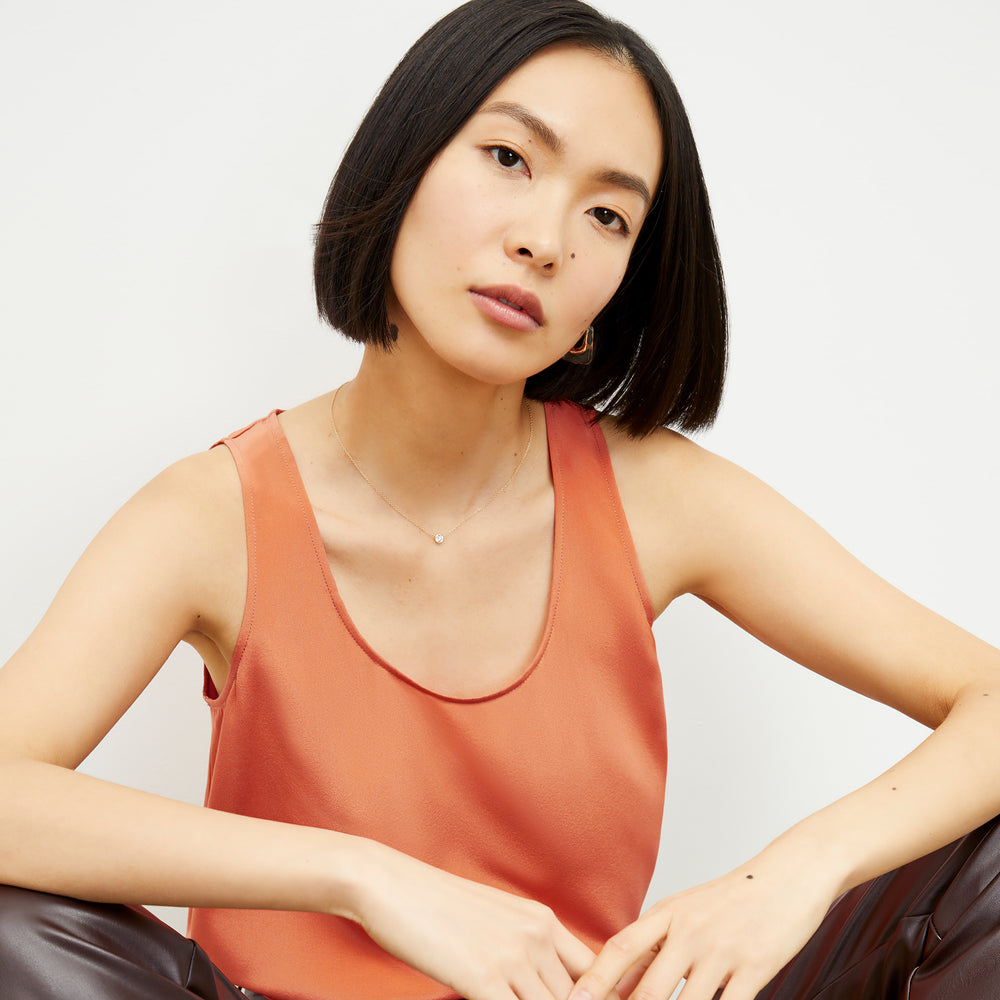Front image of a woman wearing the Vicky Tank in Guava