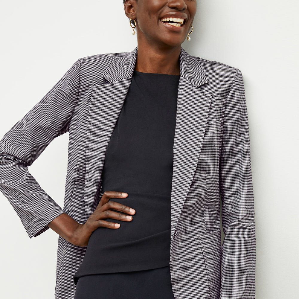 front image of a woman wearing the maisie dress in black