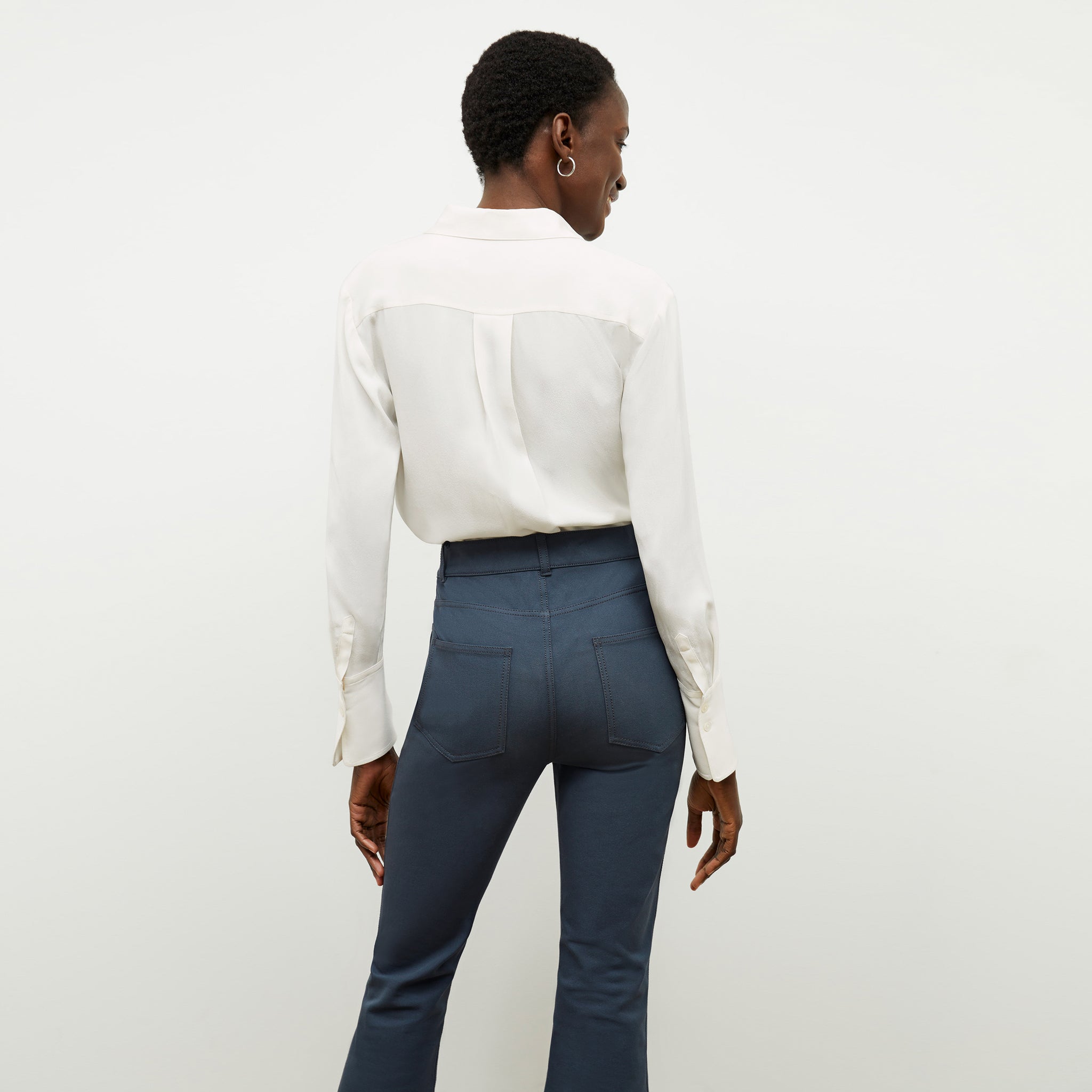 Front image of a woman wearing the tatum shirt in ivory