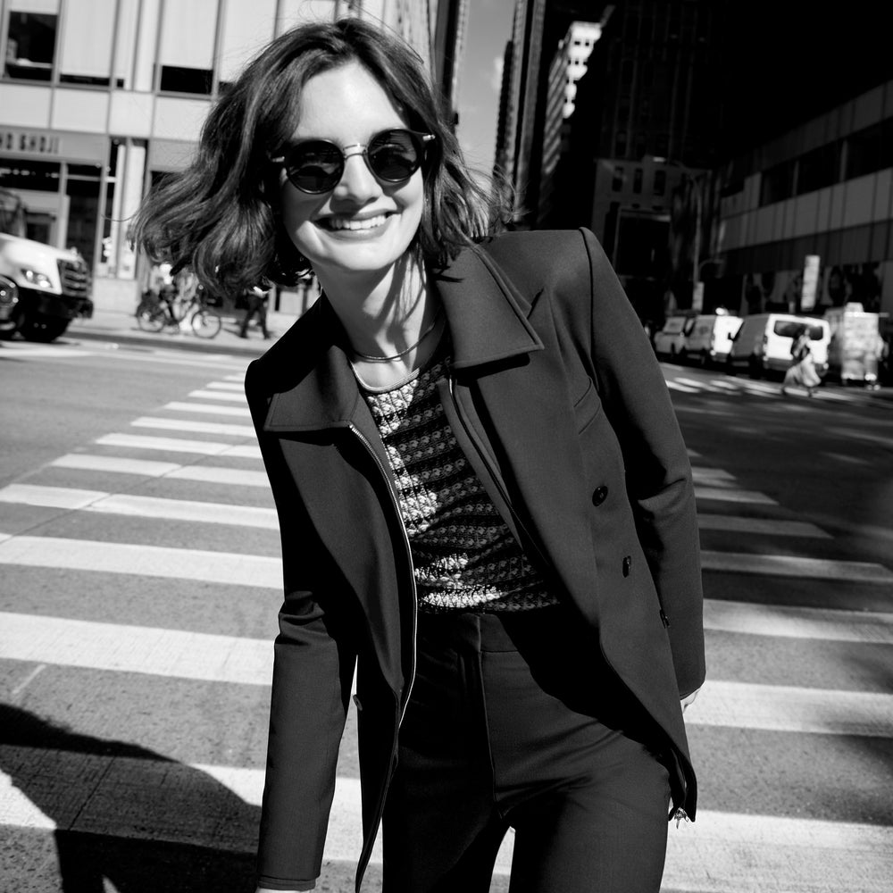 Front image of a woman wearing the kati jacket in forest