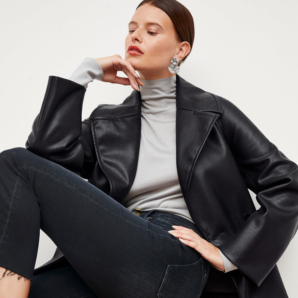 Front image of a woman standing wearing the Alphonso Jacket—Vegan Leather in Black