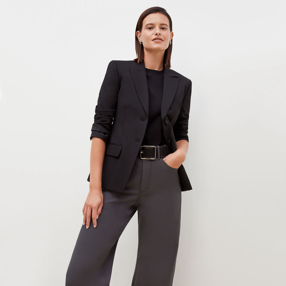 Front image of a woman standing wearing the bennett blazer wool twill in black