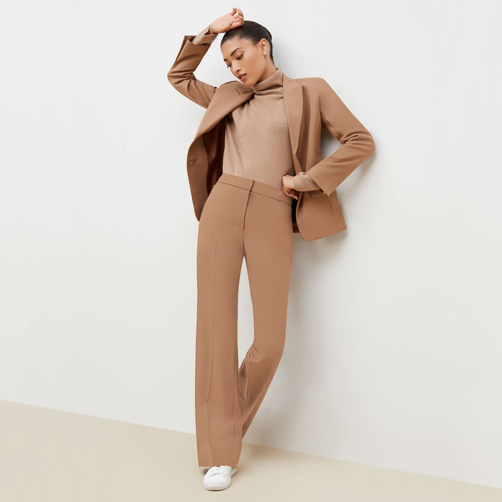 Front image of a woman standing wearing the bennett blazer wool twill in camel