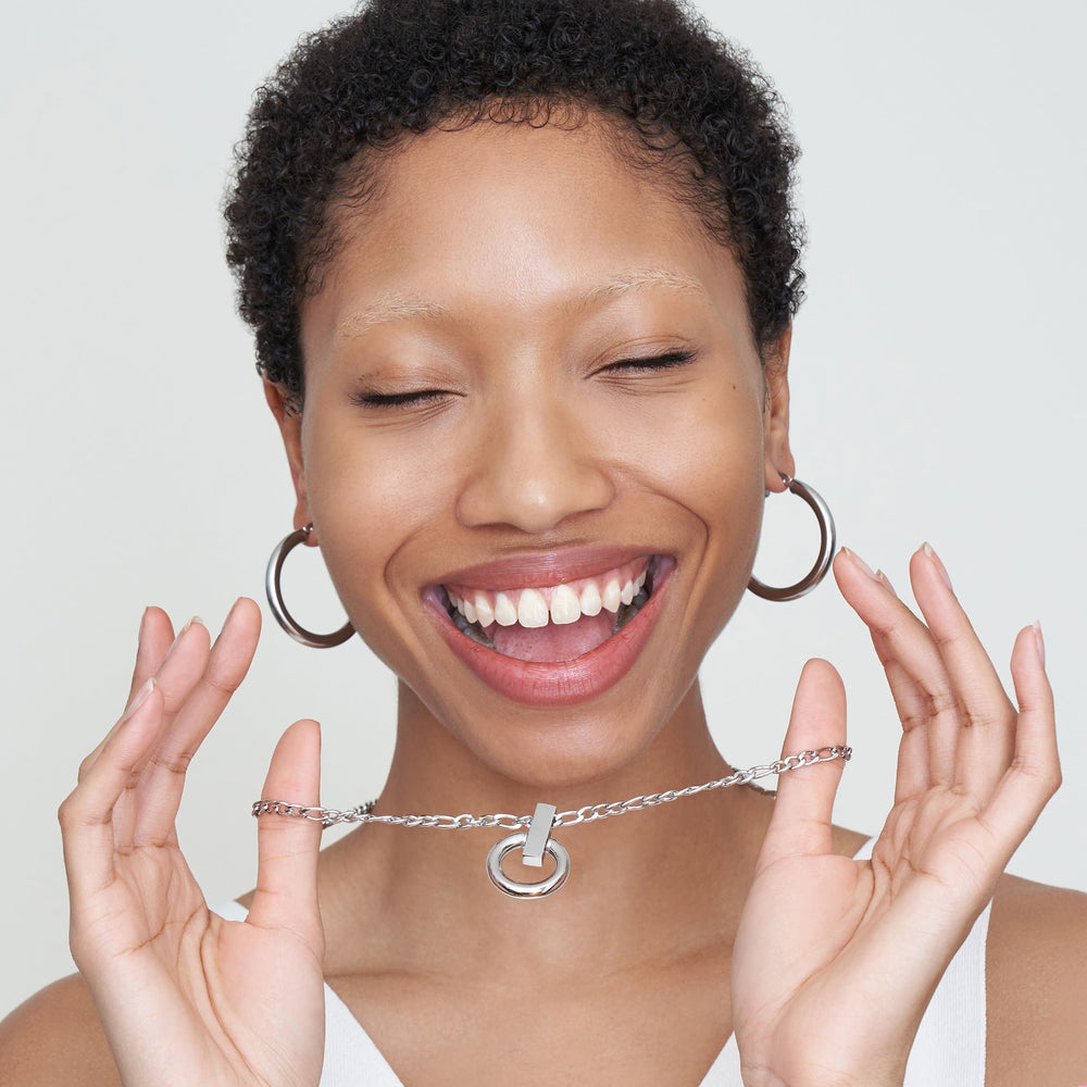 Detail image of a woman standing wearing the Claressa Earrrings Medium in Silver