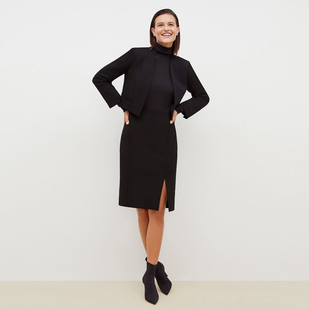 Front image of a woman standing wearing the Cortlandt Skirt--Worth in Black