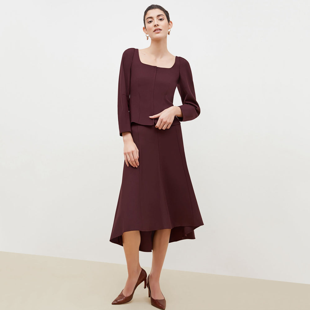 Front image of a woman standing wearing the Dawn Top-Sharkskin in garnet