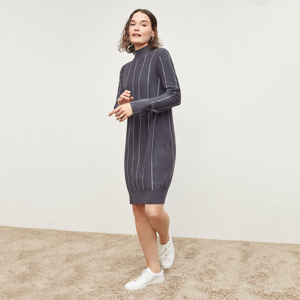 Side image of a woman standing wearing the Effy Dress—Braided Stripe in Charcoal / Ivory