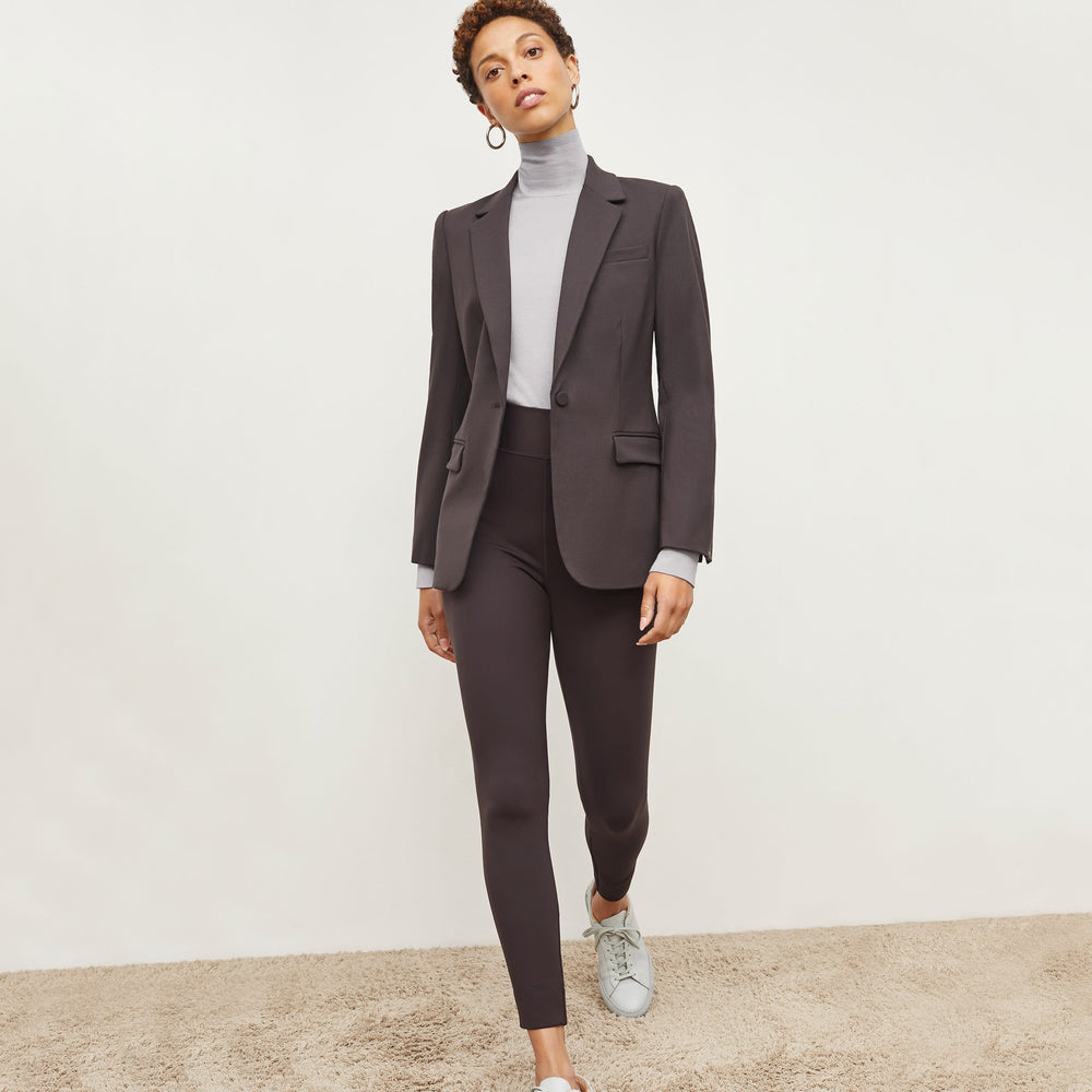 Front image of a woman standing wearing the elizabeth top in silk jersey in pale gray