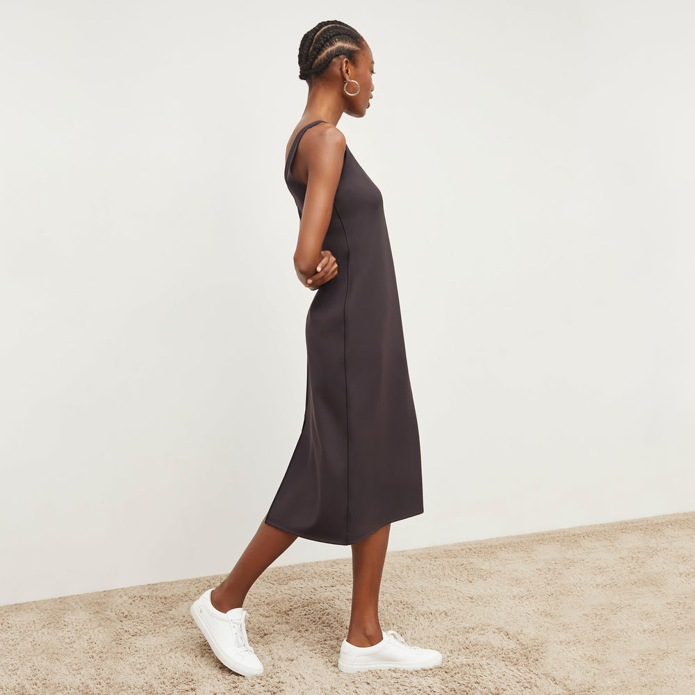Side image of a woman standing wearing the Elsa Dress—Light Scuba in Haze