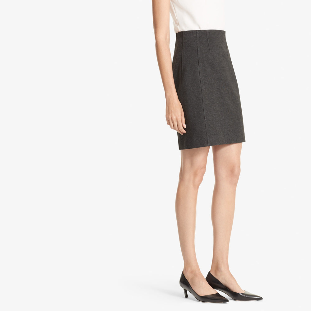 Side image of a woman standing wearing the Crosby skirt textured ponte in Charcoal