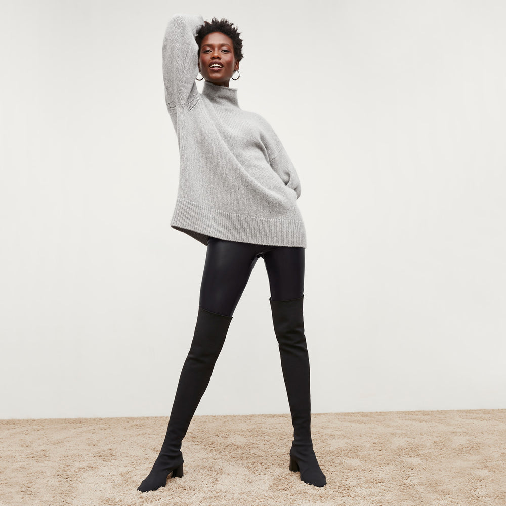 Front image of a woman standing wearing the Harrington Leather—Vegan Leather in Black