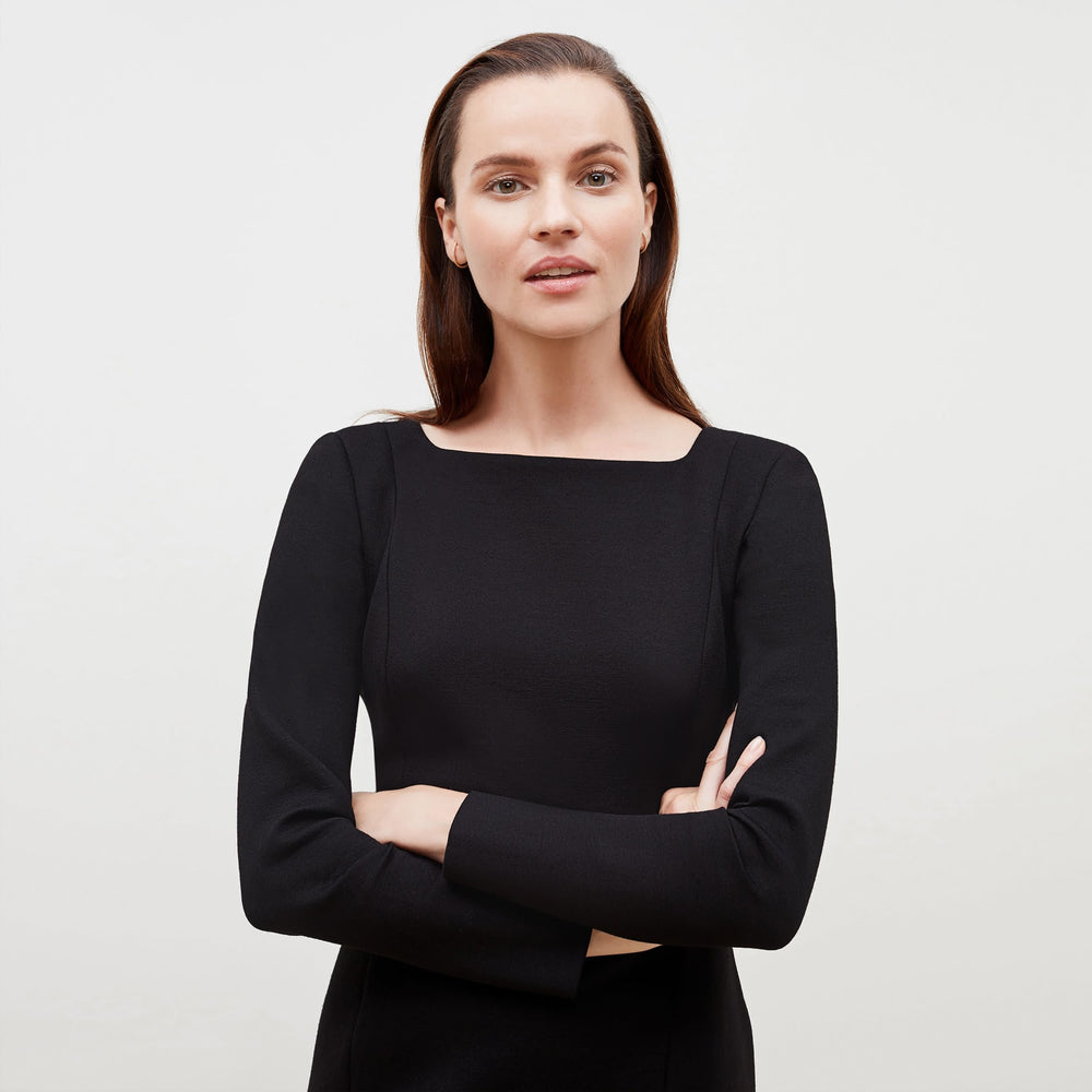 Detail image of a woman standing wearing the Joanna Dress-Worth in Black