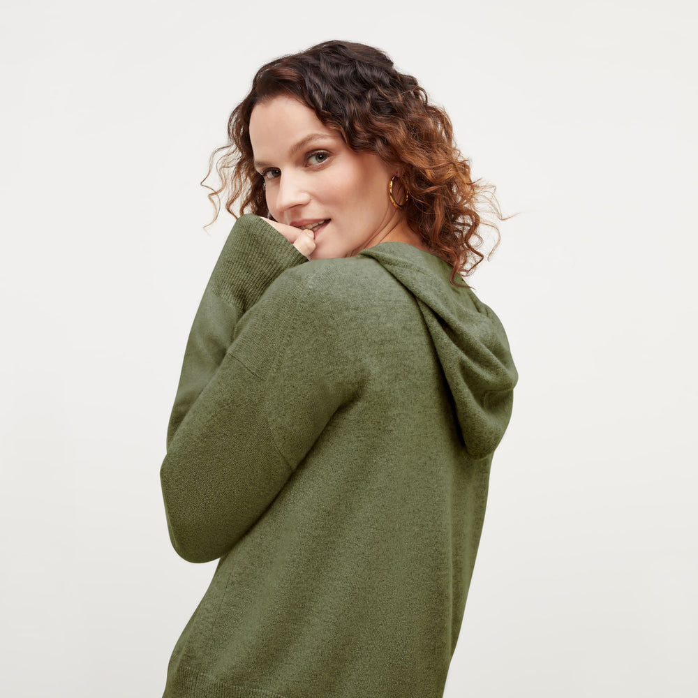 Back image of a woman standing wearing the Judith Hoodie—Cashmere in Olive
