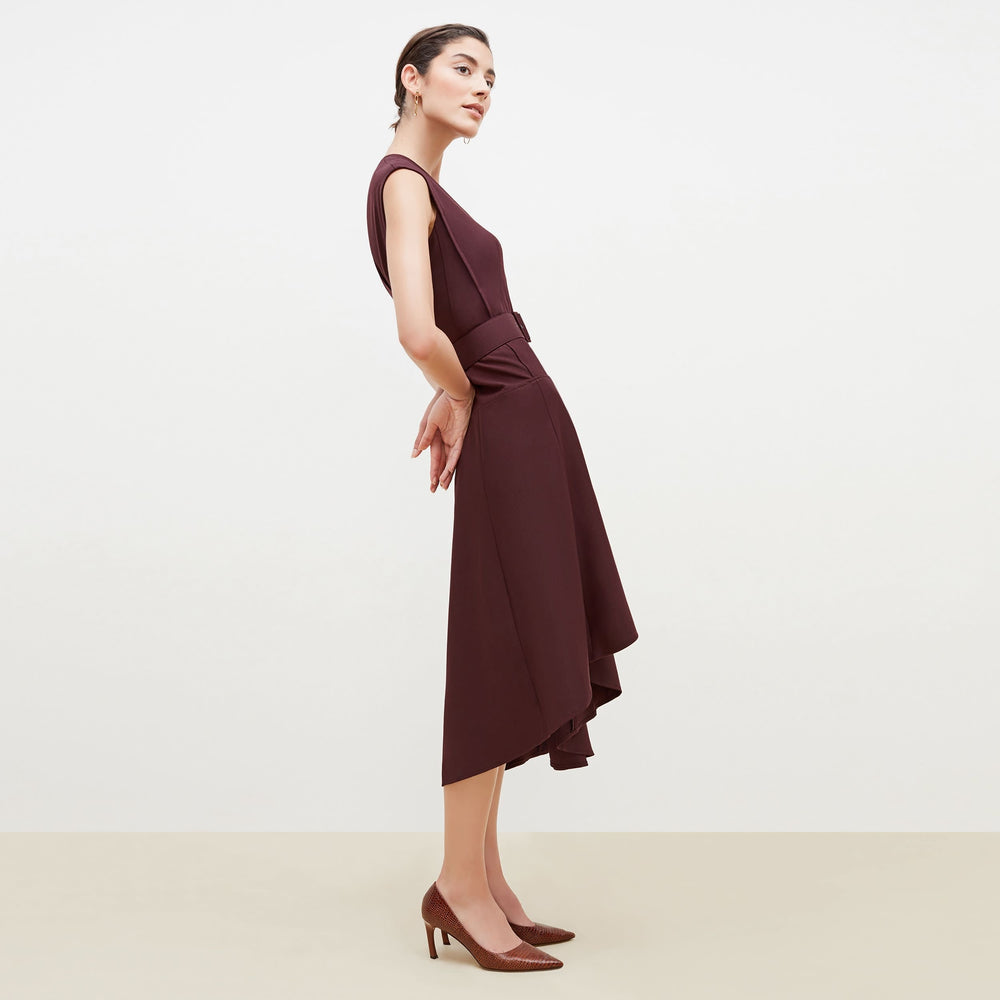 Side image of a woman standing wearing the Kelsey Dress-Sharkskin in garnet