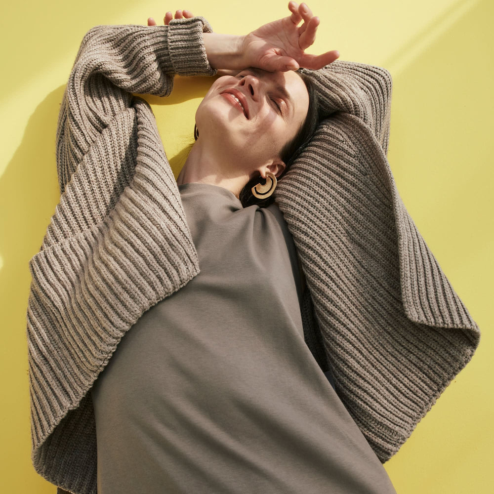 Front image of a woman standing wearing the Lou Dress—Compact Cotton in Pebble