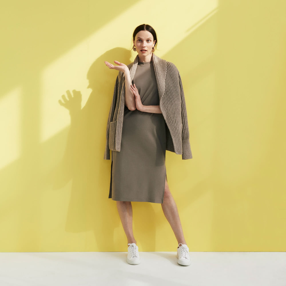 Front image of a woman standing wearing the Lou Dress—Compact Cotton in Pebble