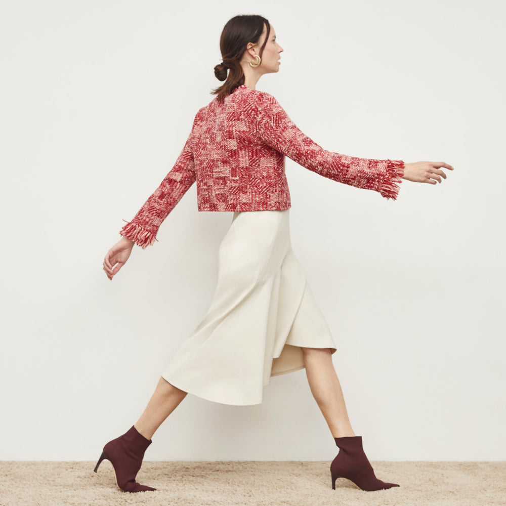 Side image of a woman standing wearing the Lilia Jacket—Interweave in Red Multi
