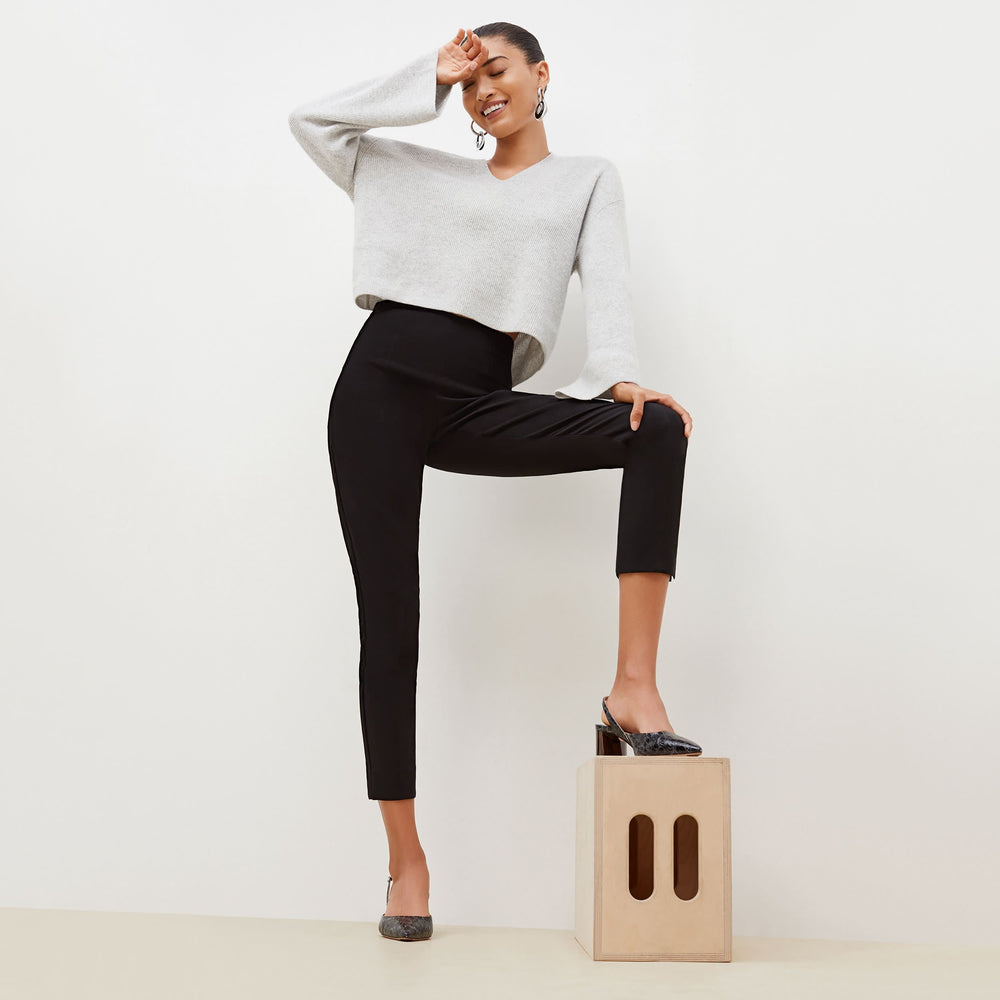 Front image of a woman standing wearing the Marais pant in black