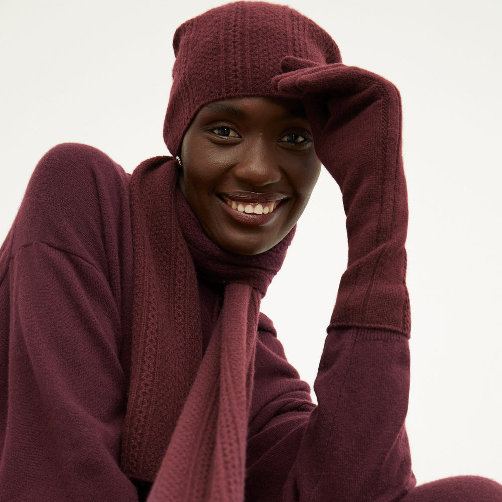 Front image of a woman wearing the circle cable scarf in chiante