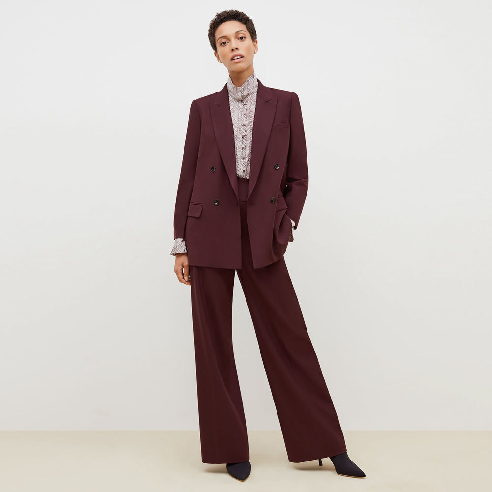 Front image of a woman standing wearing the O'Hara Blazer-Sharkskin in garnet