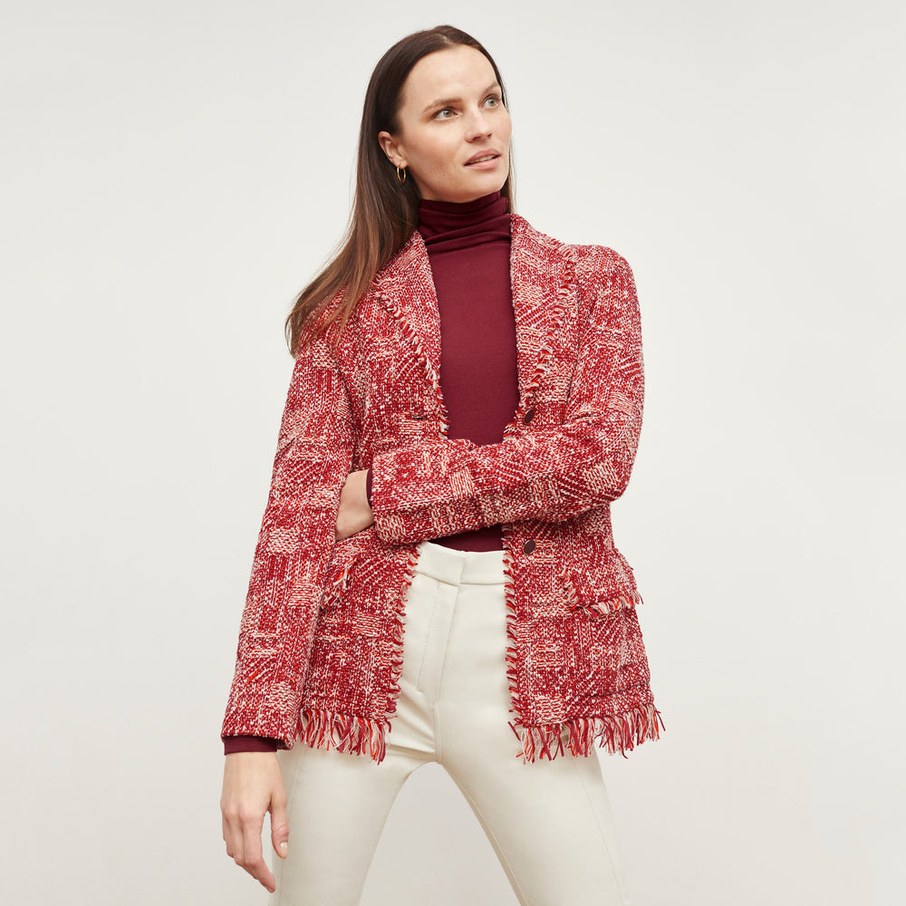 Front image of a woman standing wearing the Porter Jacket—Interweave in Red Multi