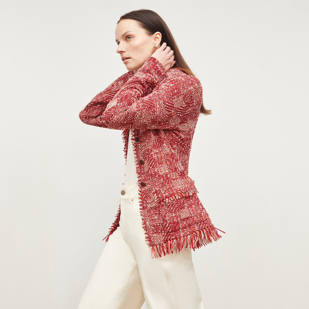 Side image of a woman standing wearing the Porter Jacket—Interweave in Red Multi