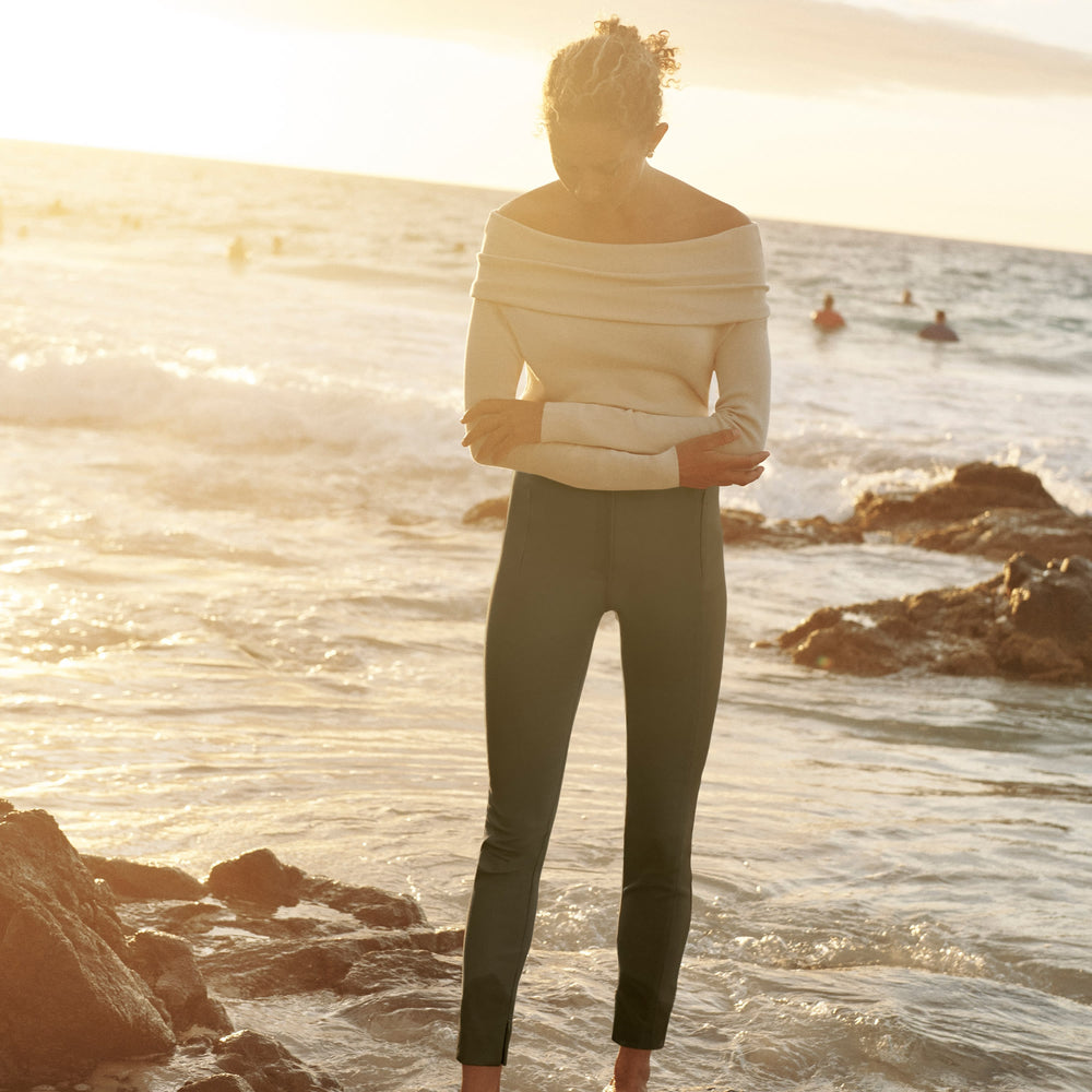 Front image of a woman standing wearing the curie pant in dark olive