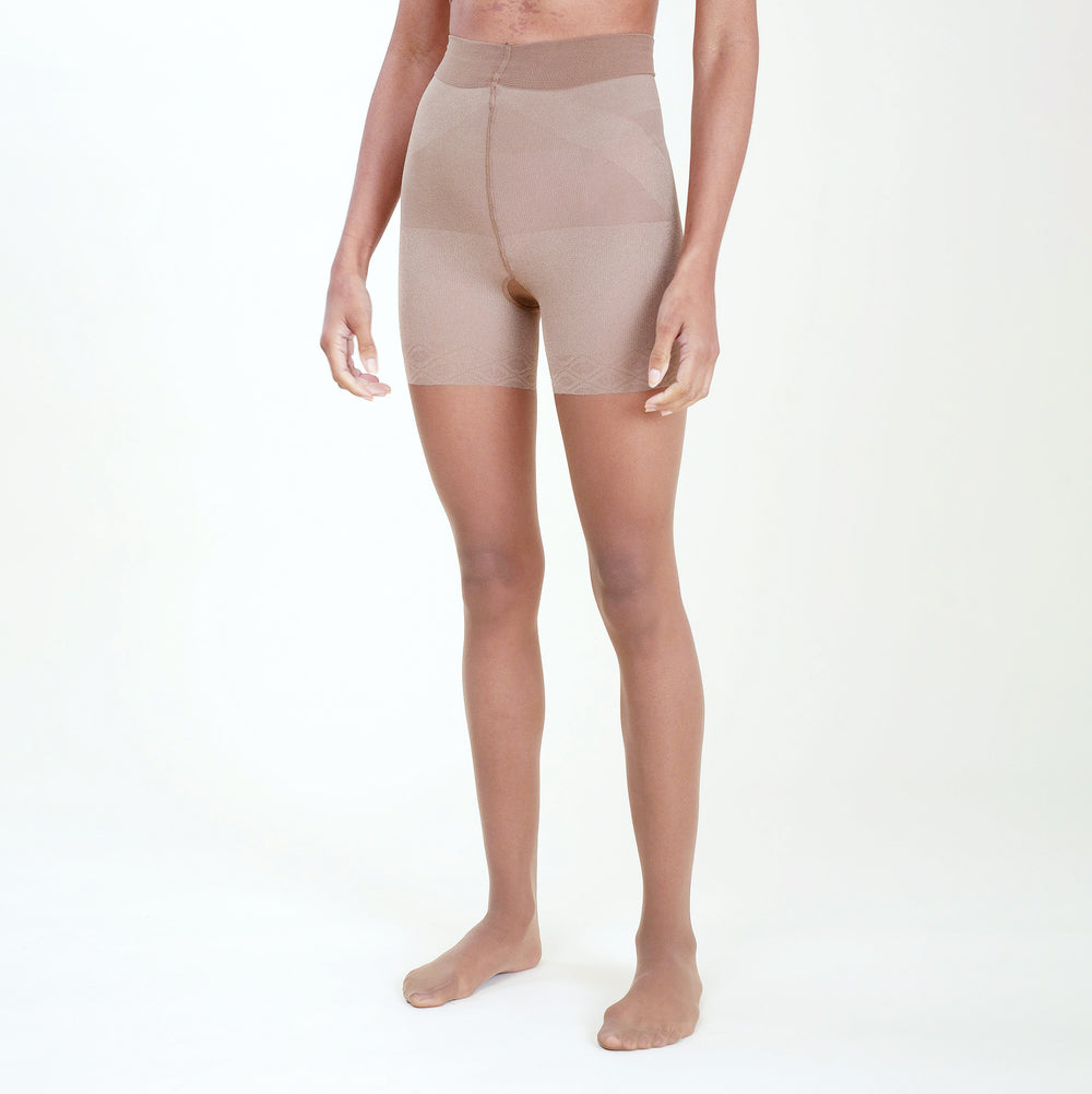 Image of a woman wearing the threads tights in sheer camel
